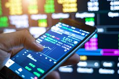 Cropped Image Of Man Checking Stock Market On Mobile Phone