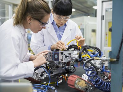 Engineers Assembling Robotics in Factory