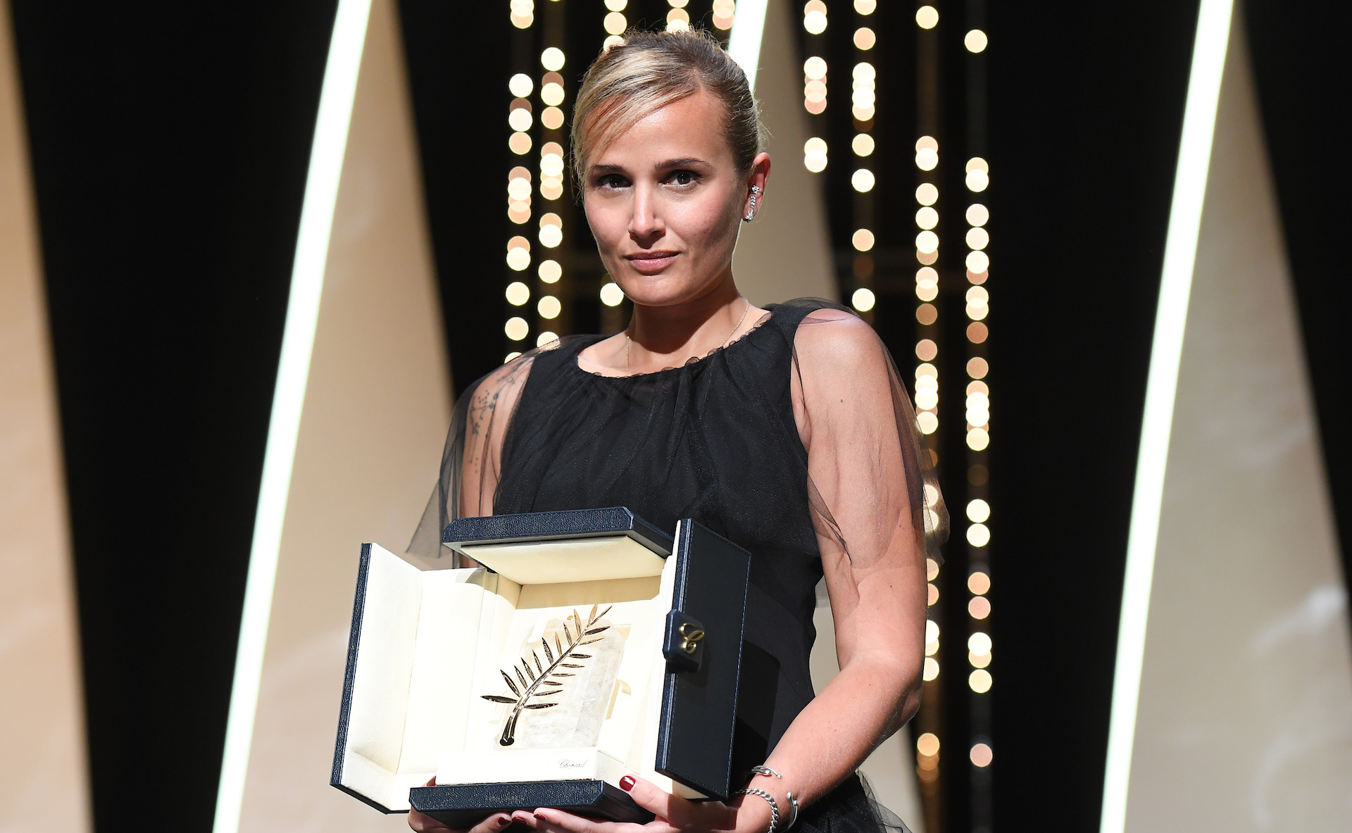 CANNES, FRANCE - JULY 17: Julia Ducournau poses with the Palme d'Or 'Best Movie Award' for 'Titane' during the closing ceremony of the 74th annual Cannes Film Festival on July 17, 2021 in Cannes, France. (Photo by Stephane Cardinale - Corbis/Corbis via Getty Images)