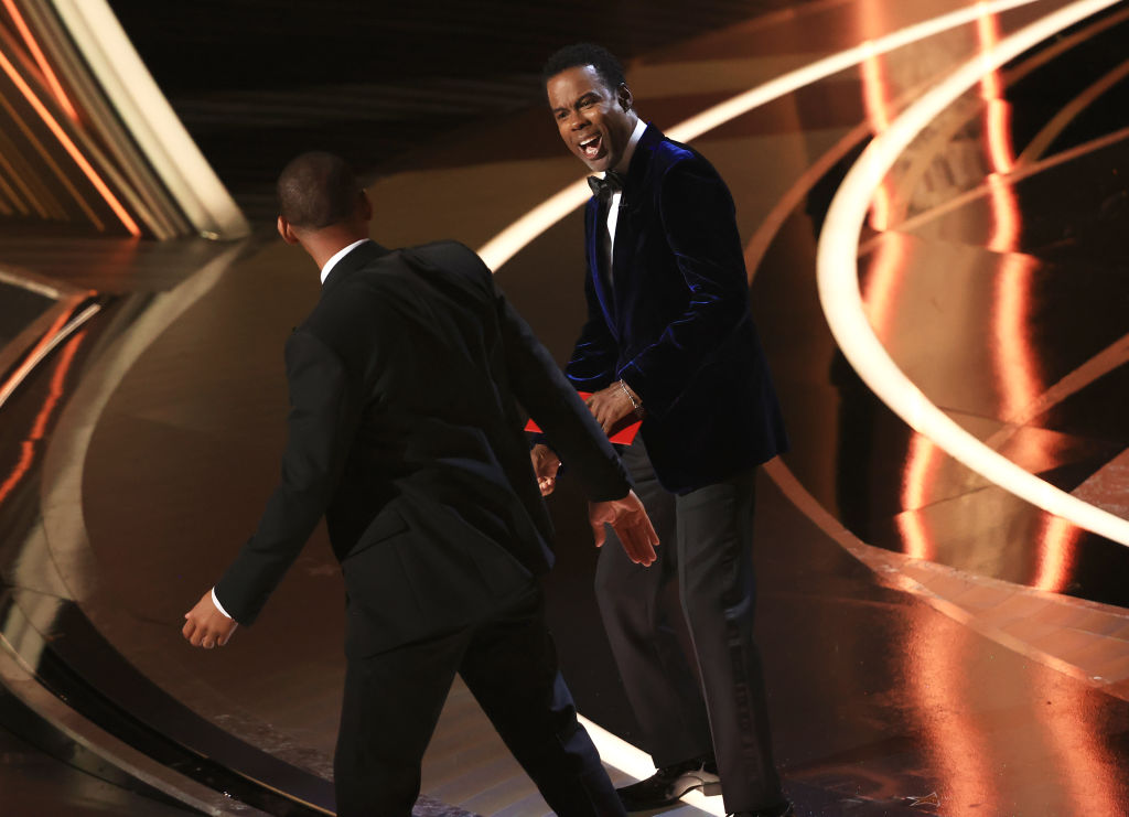 Chris Rock reacts to being slapped by Will Smith onstage at the 94th Academy Awards held at Dolby Theatre at the Hollywood & Highland Center on March 27th, 2022 in Los Angeles, California. (Photo by Chris Polk/Variety/Penske Media via Getty Images)