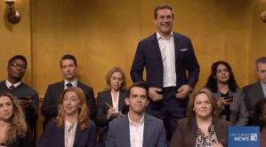 Jon Hamm in 'Saturday Night Live,' standing up in the middle of a press corps