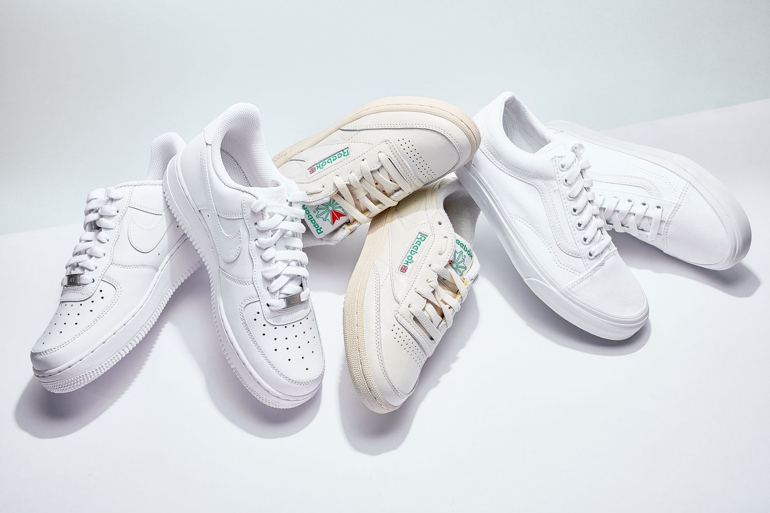 Assortment of the best white sneakers we recommend on a white background