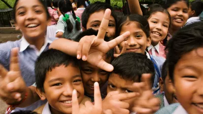 A group of school children smiling at the camera.