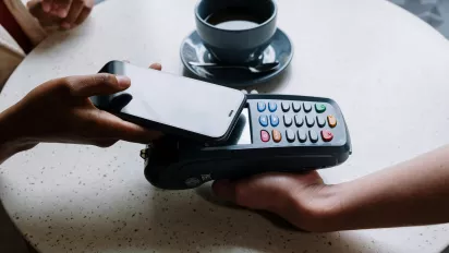 Person making a payment on their smartphone.
