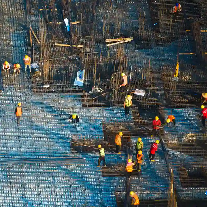 Construction workers position a vast sea of rebar.