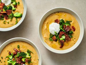Three bowls of fully loaded vegan baked potato soup
