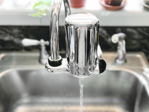 a water faucet filter filtering water
