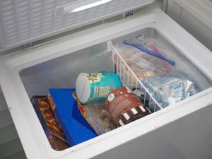 a chest freezer with the lid open revealing what's inside 