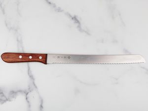 tojiro bread knife on marble counter