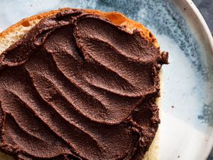 Overhead closeup of a slice of bread smothered with crispy homemade nutella.