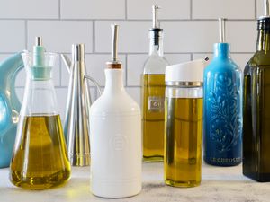 An assortment of olive oil dispensers on a marble counter