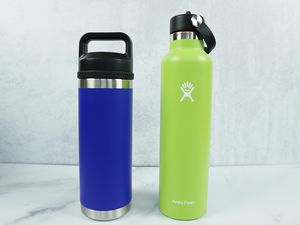 a HydroFlask and a Yeti water bottle side-by-side on a marble surface