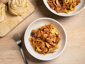 Two bowls filled with pasta and mushroom ragù.