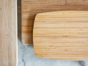 three wooden cutting boards on a marble surface