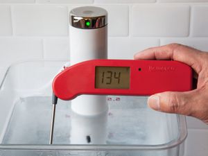 A Thermapen one taking the temperature of a sous vide water bath set to 134 degrees