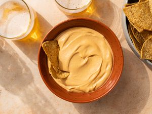 The Best Vegan Nacho Cheese Sauce in a bowl, served with chips 