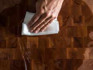 wiping mineral oil over a wood board