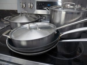 a variety of cookware on a stovetop