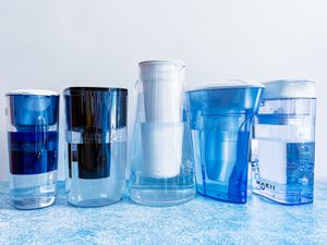 the lineup of water filter pitchers on a blue countertop