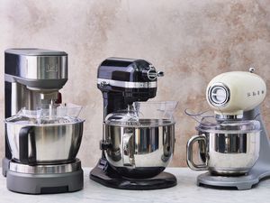 three stand mixers on a grey surface