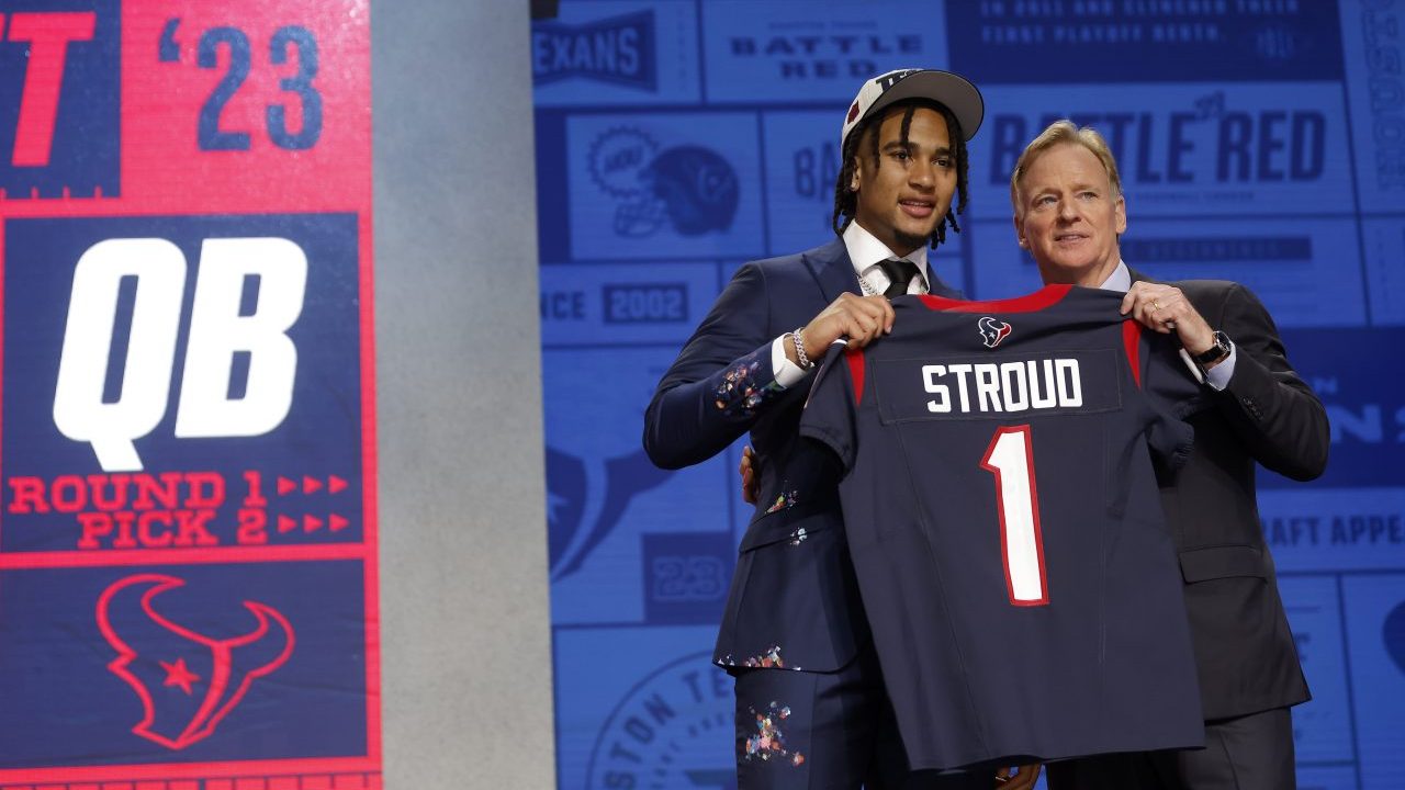 C.J. Stroud and Roger Goodell hold up Texans jersey at NFL draft