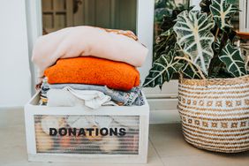 donations box full of clothes for charity at the entrance of house