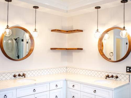 beautiful mirrors and lighting compliment this bathroom remodel in Raleigh NC