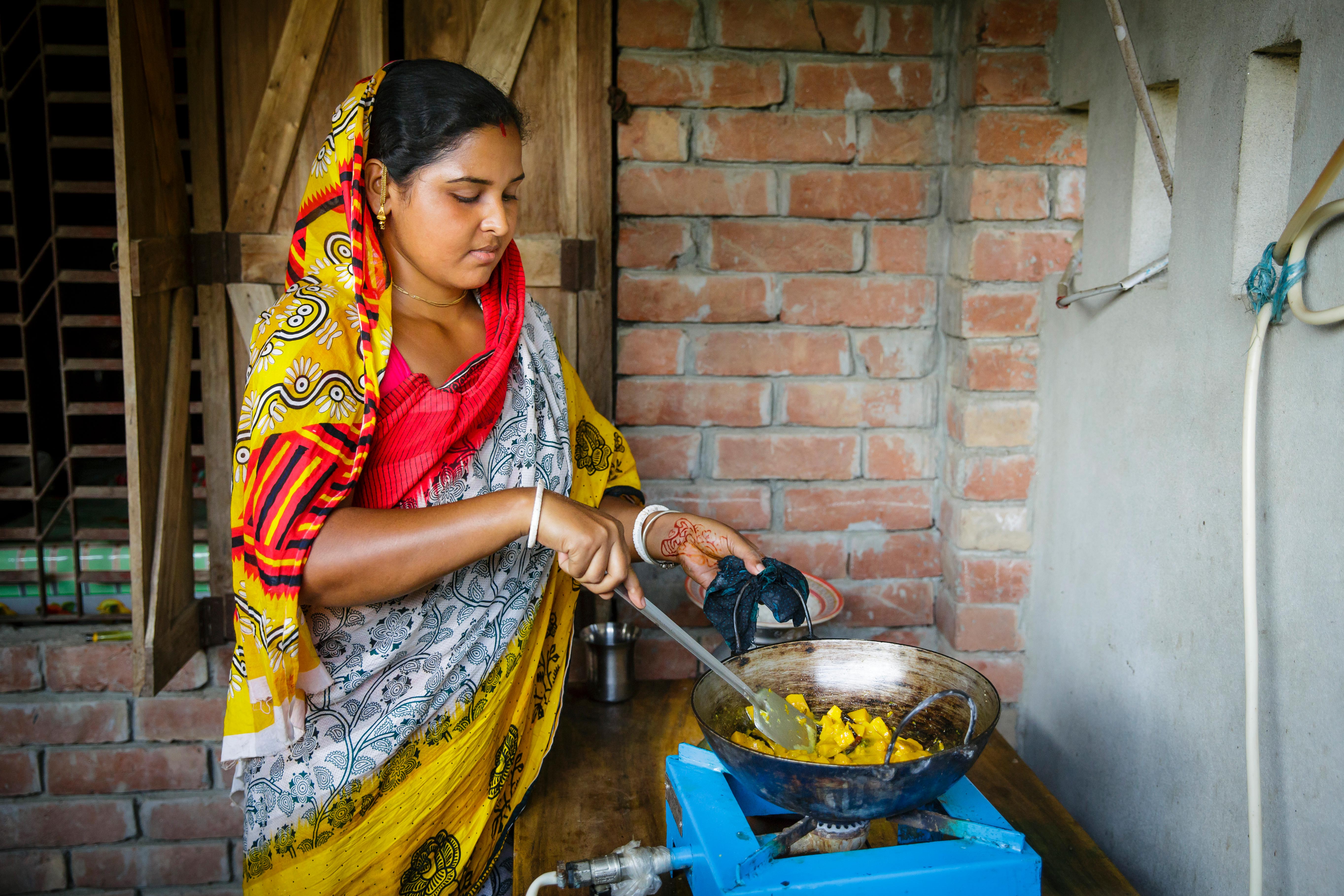 Women cooking on a gas stove