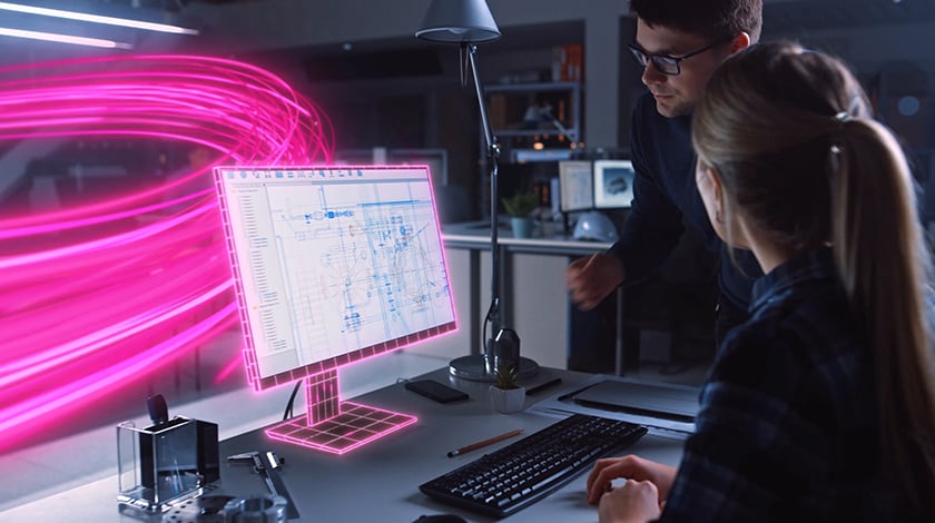 Dos personas mirando el monitor de una computadora que está envuelto en una red de luz magenta con rayos de luz magenta arremolinados detrás