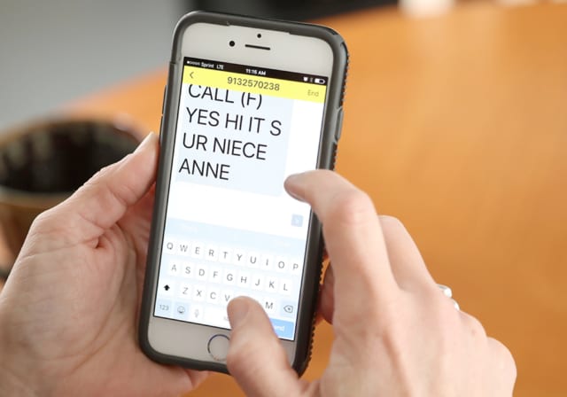 A person looking at a spam text message.