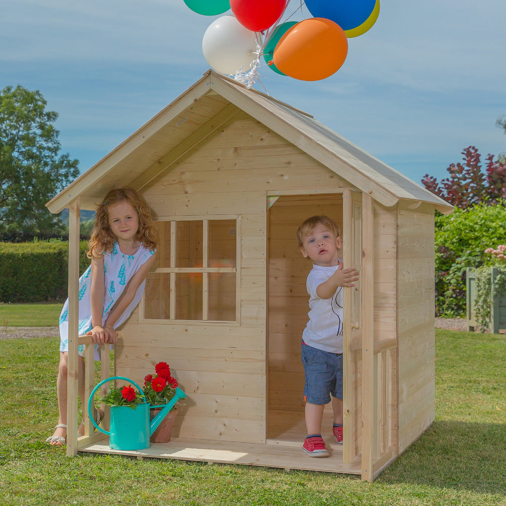 Children playing in a wooden playhouse