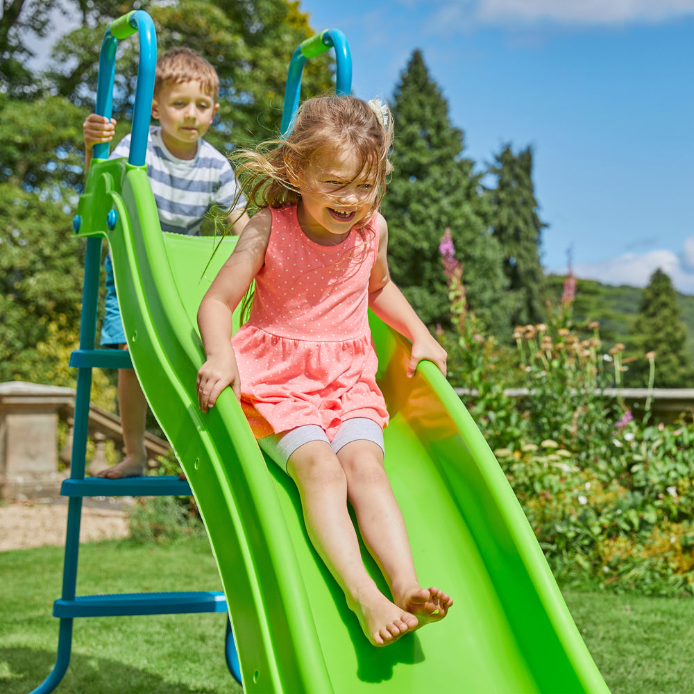 Two children playing on a kids plastic garden slide & stepset
