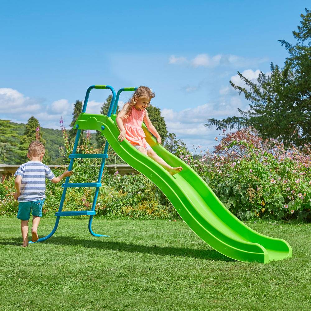 Two children playing on a garden slide