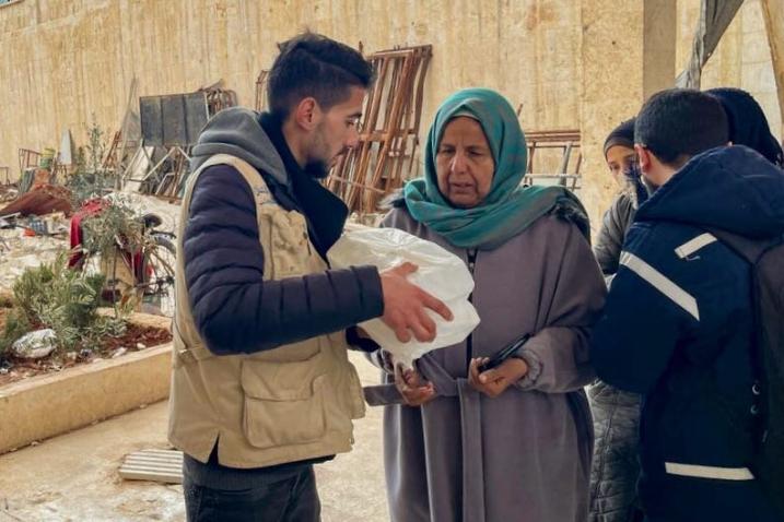 In Idlib, Syria, a woman receives WFP ready-to-eat rations following the deadly quakes.