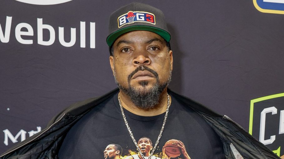 Ice Cube at BIG3 Celebrity Game, wearing a Black jacket, Black shirt, and Black hat.