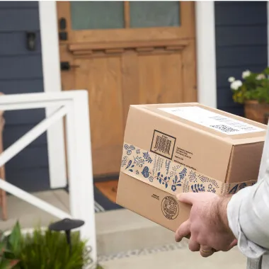 A delivery box in the hands of Veho delivery partner.