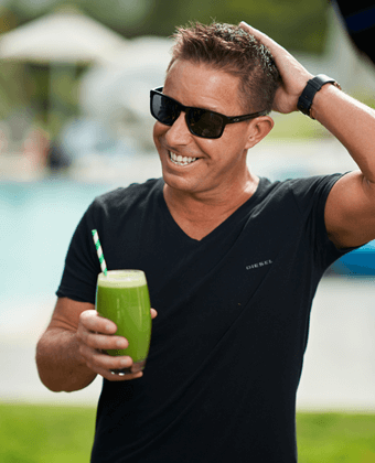 Jason Vale holding a green juice