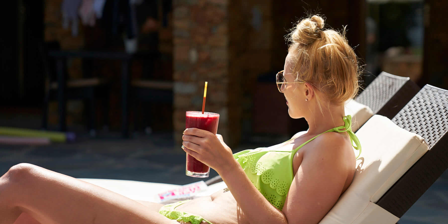 Lady drinking juice on a sun lounger at Juicy Mountain