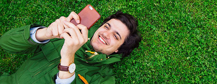 Person on their phone in the grass