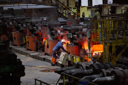 Steel workers ensuring defect-free production