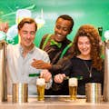 Tourists at the Heineken Experience pouring a beer