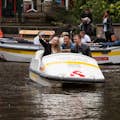 Friends in a pedal boat taking selfies in the Amsterdam Canal