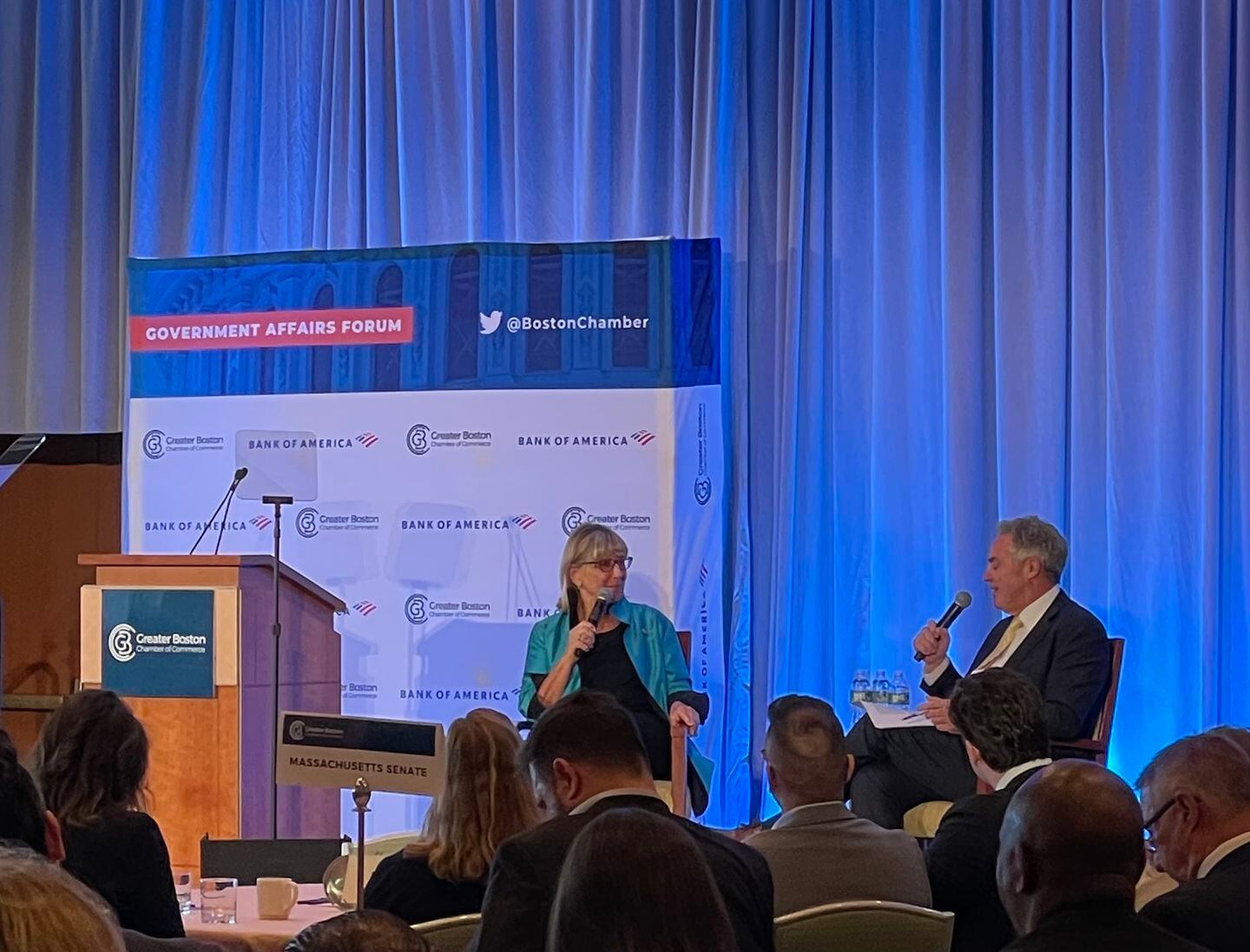 Senate President Karen Spilka, left, speaking with Greater Boston Chamber of Commerce chief Jim Rooney. During the Q&A, Spilka expressed her opposition to a state ballot question that would end the use of MCAS tests as a high school graduation requirement in Massachusetts.