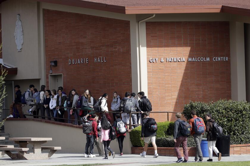 Students walk between buildings at St. Francis High School Friday, March 3, 2017, in Mountain View, Calif. The red-hot IPO debut of vanishing-photo superstar Snap this week not only placed the Southern California startup at a $35 billion value. It also made Mountain View, Calif.'s Saint Francis high school $23 million richer. The Catholic school had invested $15,000 in Snap's early round of funding way back in 2012. By the time shares in Snap had finished trading Thursday afternoon, that pittance had turned into a big fat pile of shareholder value. (AP Photo/Marcio Jose Sanchez)