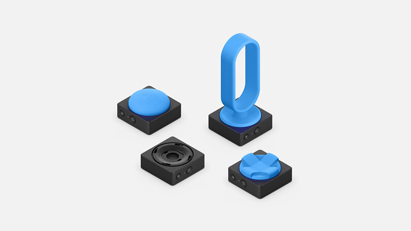 Microsoft Adaptive Buttons with 3D printed button toppers in many shapes and sizes.
