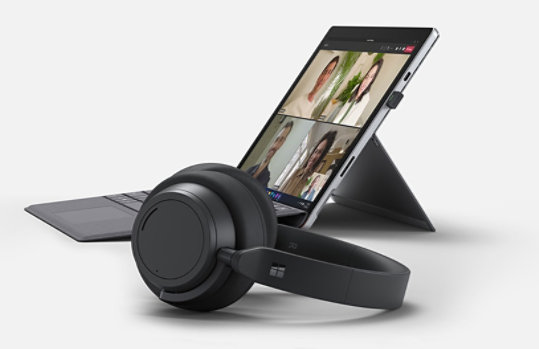 Side profile of a Surface Pro 7+ with Surface Headphones 2+ in the foreground