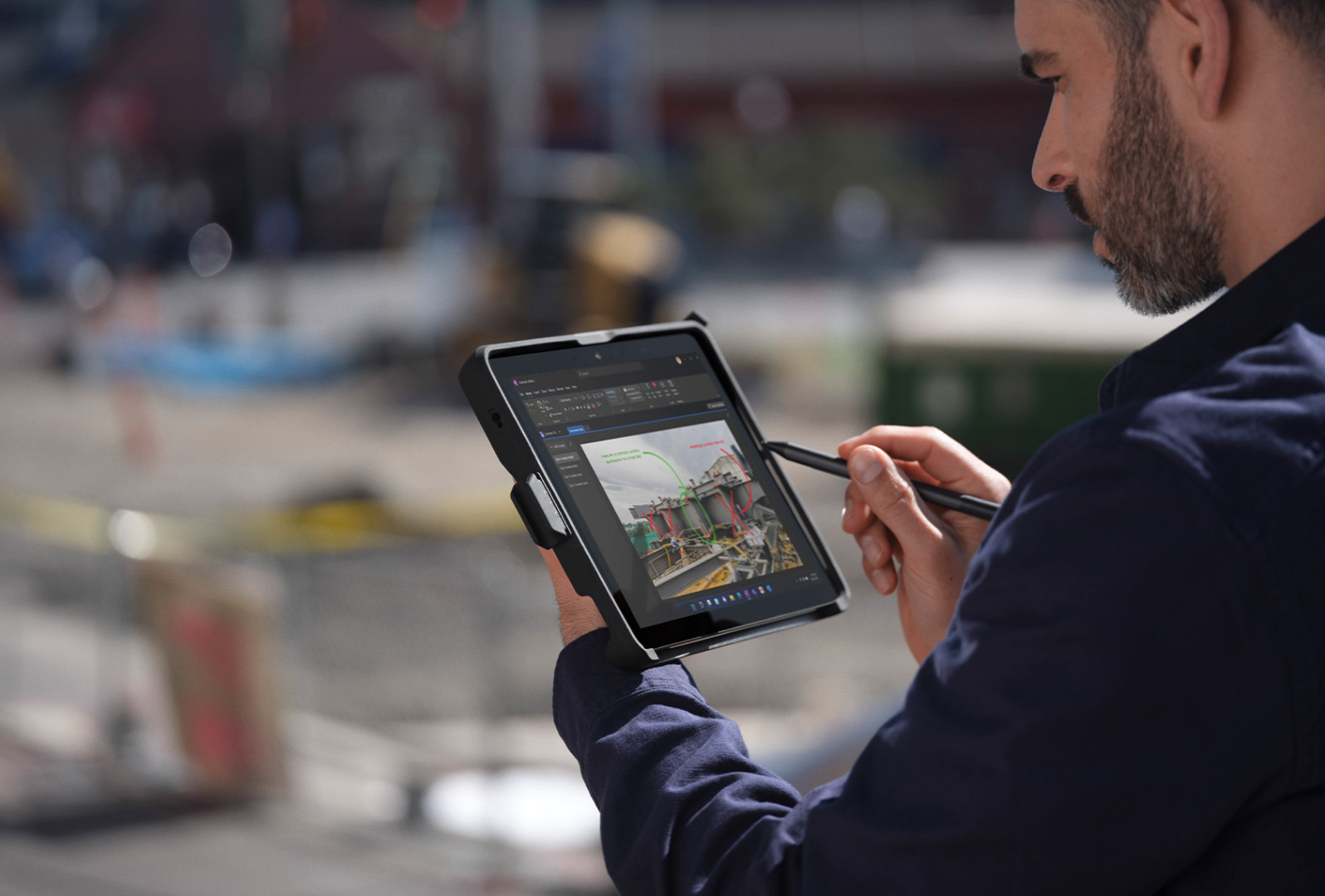A person on-the-go at a job site uses Surface Pen to navigate Surface Go 4