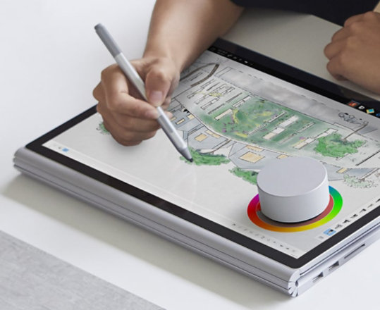 An artist using a Surface Dial to adjust colors.
