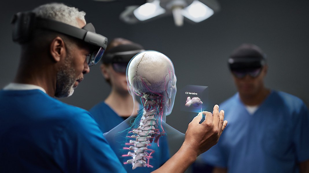 Medical professionals using HoloLens 2 devices to view a human spinal cord.