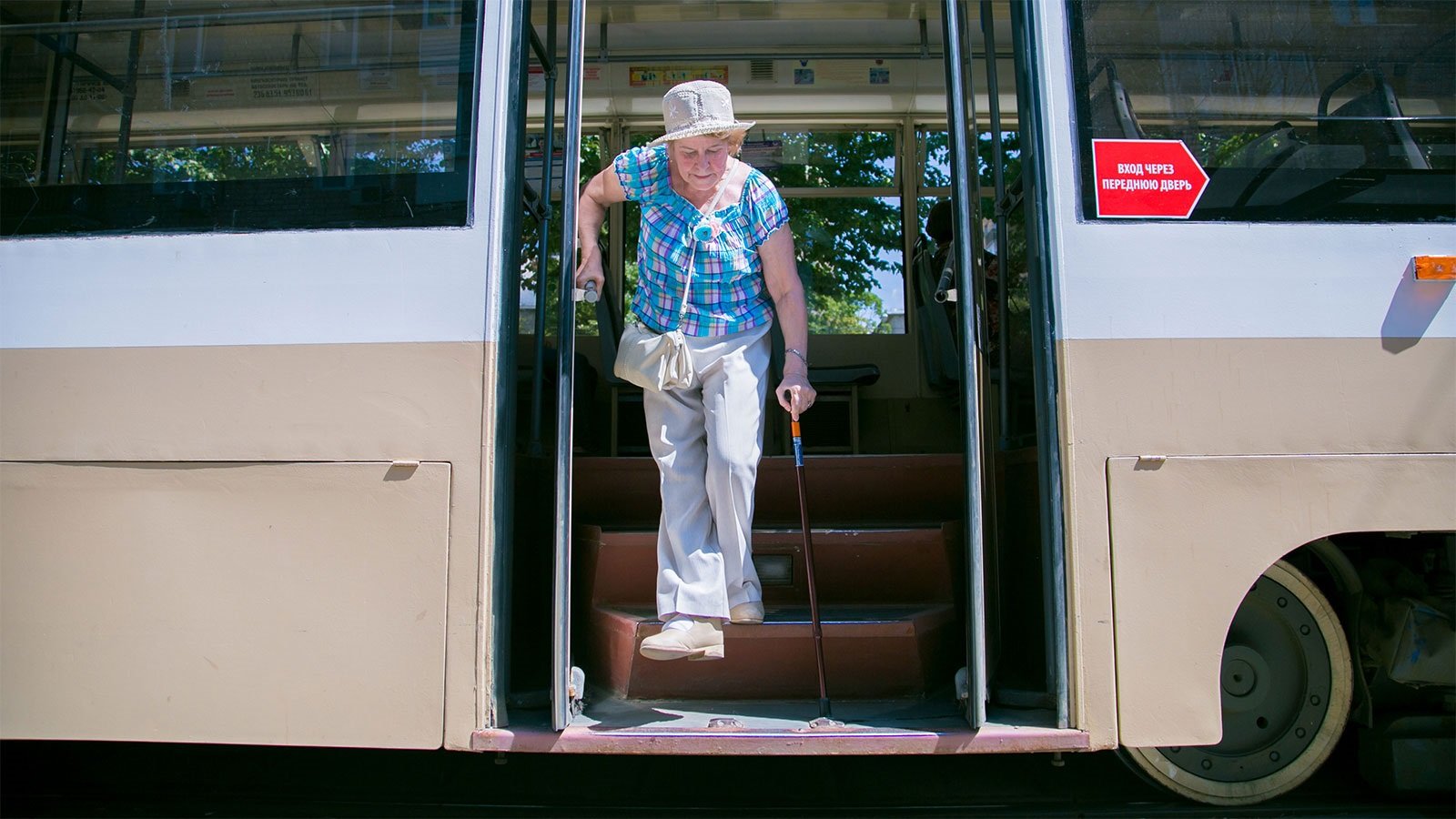 Photo of an elderly woman getting off a tram in Moscow, Russia.